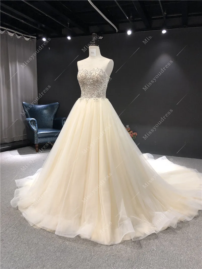 2021 Newest High Quality Real Sample Champagne Sweat Strapless Sleeveless Ball Gown Heavy Beadings Floor Length Wedding Dress