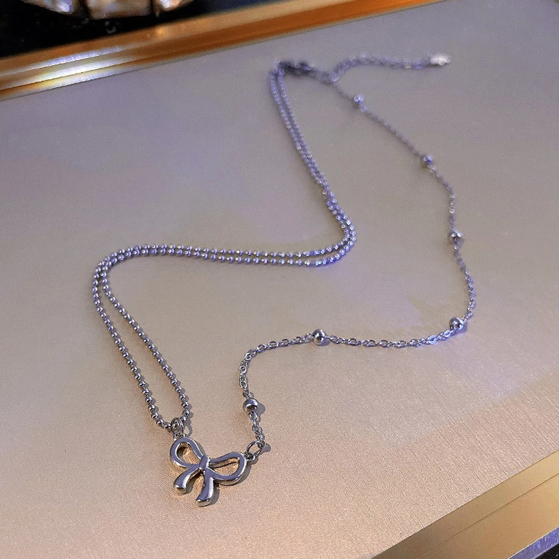 

Korean fashion personality unsymmetrical bow titanium steel necklace female temperament exquisite collarbone chain