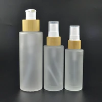 wholesales full carton of luxury empty cylinder cosmeticos frosted serum glass bottle with bamboo cap