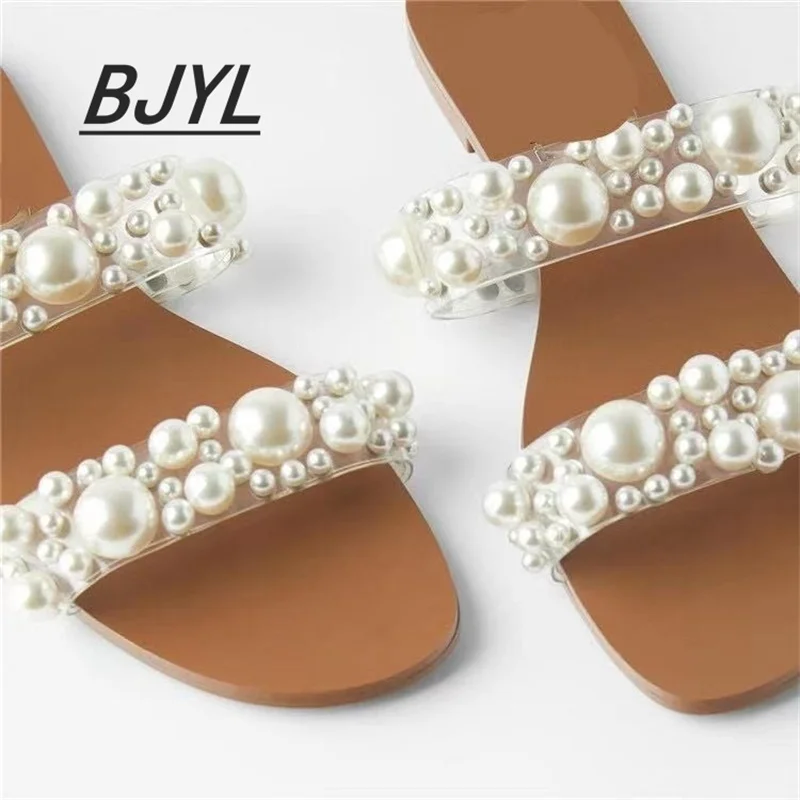 

Women's shoes 2021 new transparent flat pearl one word belt sandals large size slippers women