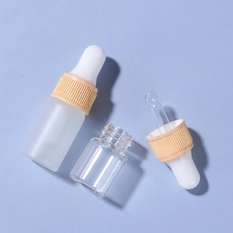

1 мл 2 мл 3 мл 5 мл мини прозрачная матовая стеклянная флакон-капельница с пластиковой деревянной крышкой для образца косметики с эфирным масл...