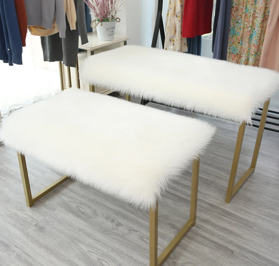 

Plush Faux Fur table top laid with rectangular fluffy cushion items placed fluffy covered table blanket