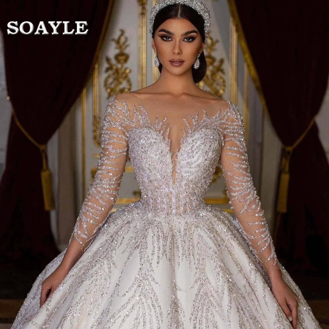 

Arabic Stunning Sequins Wedding Dresses Crystals Long Sleeve Vintage Bridal Gowns Bling Bling Open Back Luxury vestido de novia