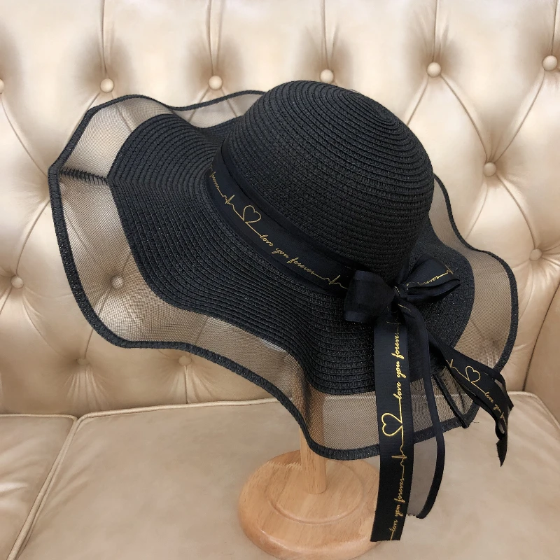 

New beach holiday big eave wavy straw hat female Korean version of the alphabet bow ribbon romantic net sun hat