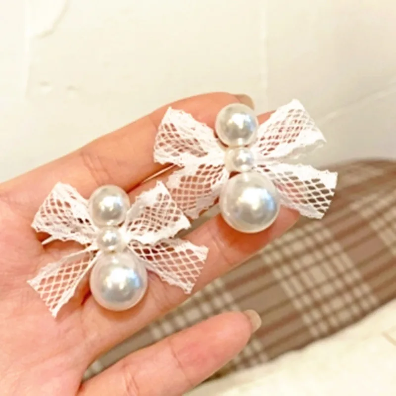 

S925 Silver Needle Korean Lace Bowknot Emulation Pearl Simple Cold Wind Temperament Earrings Female