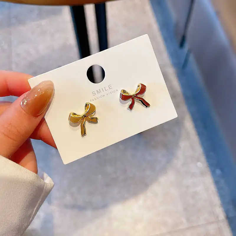 

S925 silver needle asymmetric Bow Earrings simple women's small oil dripping temperament Earrings Fashion Design Earrings