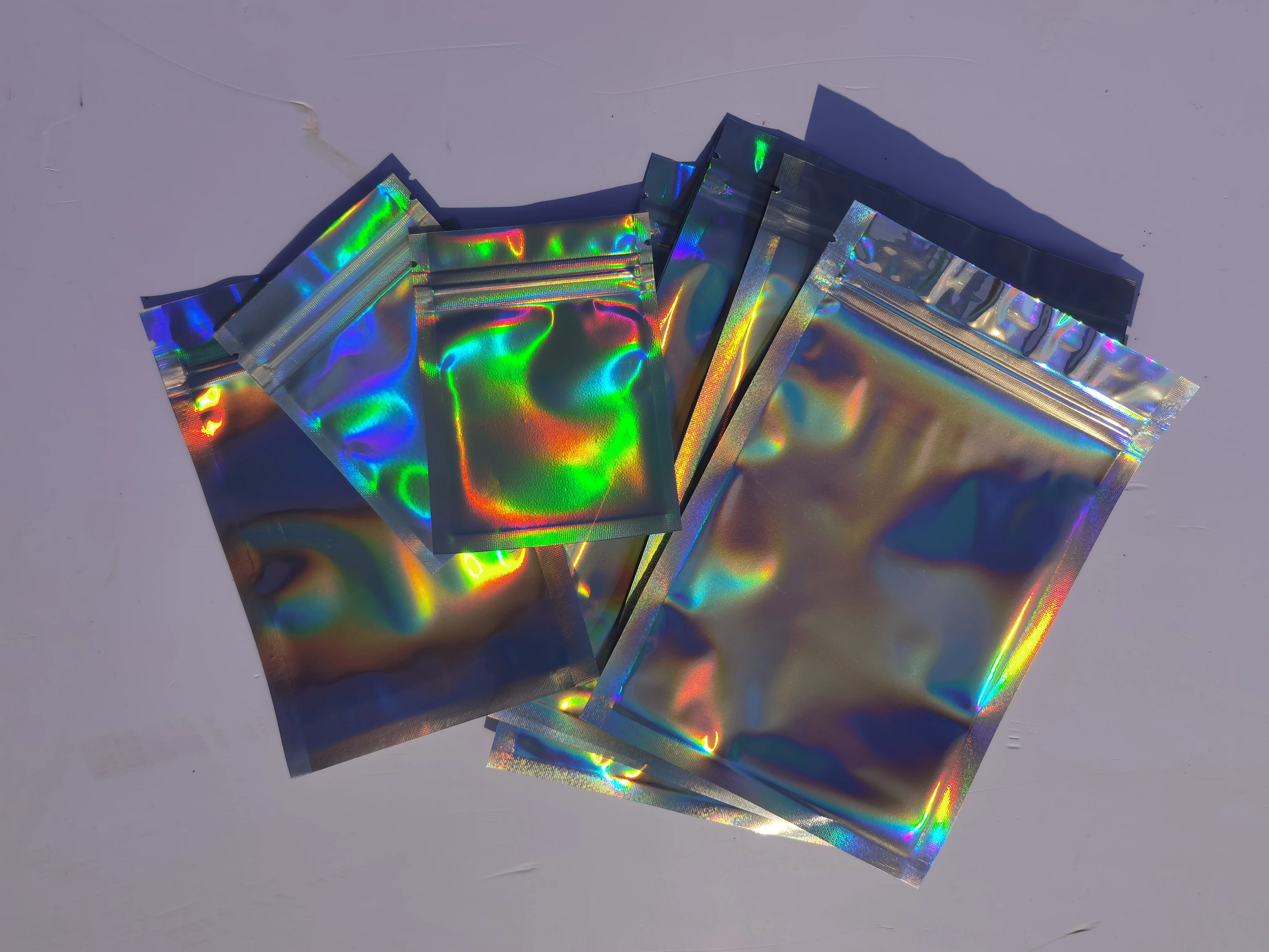 

50pcs Laser Metallic Mylar Zip lock Bags Clear Aluminum Foil Hologram Zip lock Plastic Pouch Moisture Proof Food Storage Bags