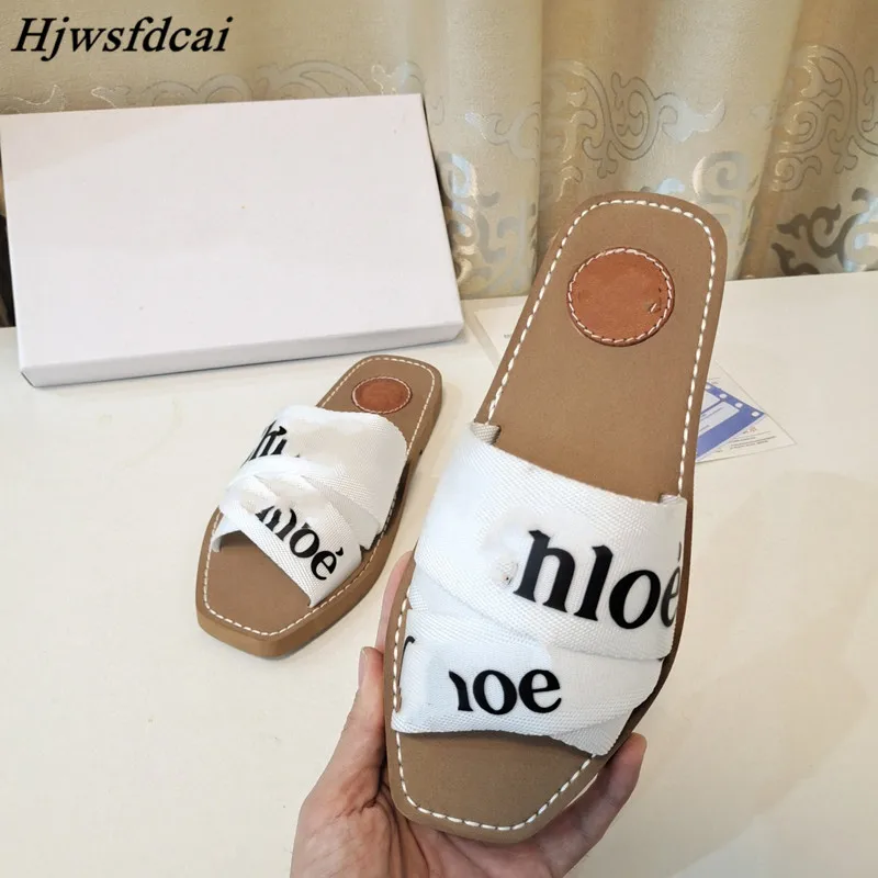 

Hjwsfdc 2021Summer New Word Buckle Canvas Flat Shoe Fashion Square Toe Embroidery Letter Slippers Women Casual Beach Flip Flops