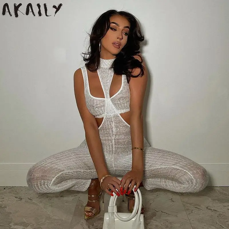 

Akaily White See Through Jumpsuit Sexy Club One Piece Outfits For Women 2021 Halter Hollow Out Bodycon Jumpsuit Ladies Clubwear