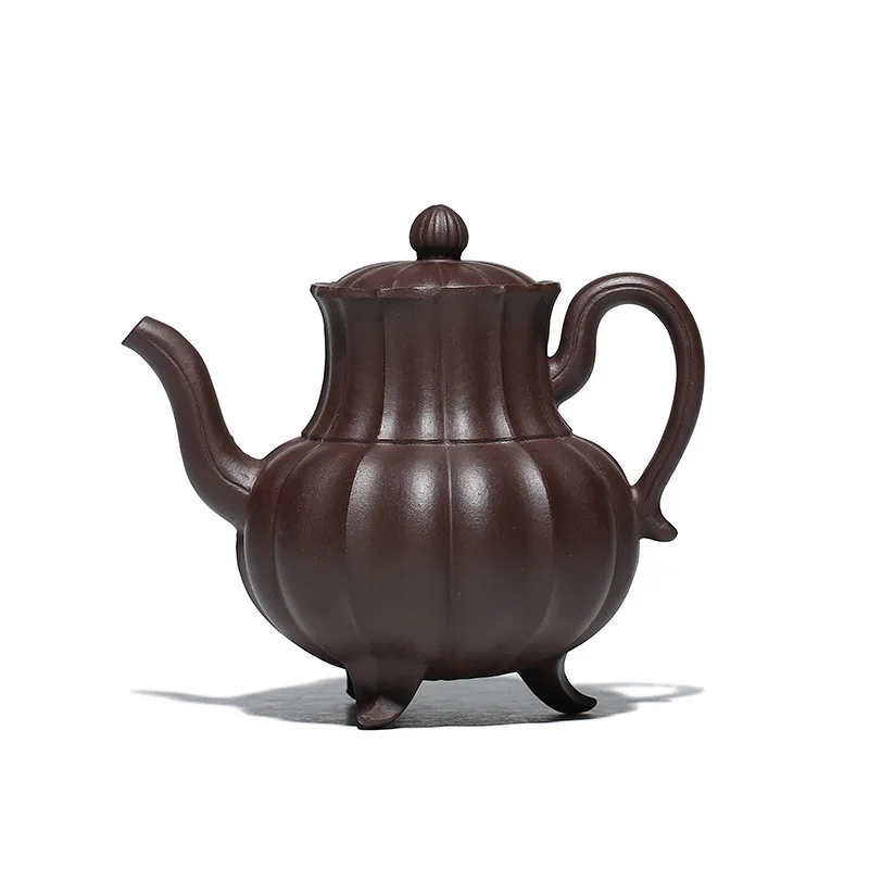 

Purple clay teapot with three legs standing together