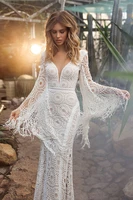 bohemian fringe long bell sleeves plunge neck backless sheath shape decorative lace trim boho chic style modern wedding dress