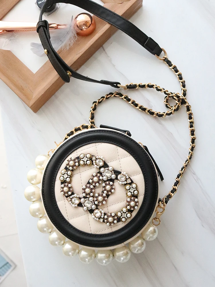 

In the autumn of 2019, the new tide women's small round pearl bag hand bill of lading shoulder messenger bag diamond chain bag