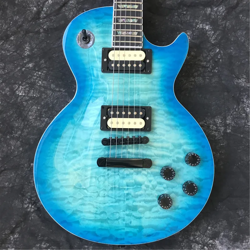

Custom high-quality electric guitar, blue, maple flame top. Black pieces, true color shell inlays