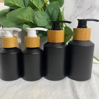 wholesale cosmetic packaging slant shoulde frosted black skin care set glass bottle cosmetic bottle products with bamboo cap