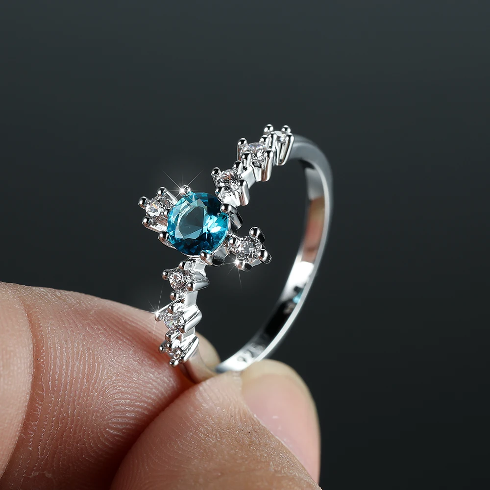 

Dainty Aqua Blue Zircon Cross Ring for Women Silver Color Bridal Wedding Engagement Rings Creative Design Finger Jewelry Gift