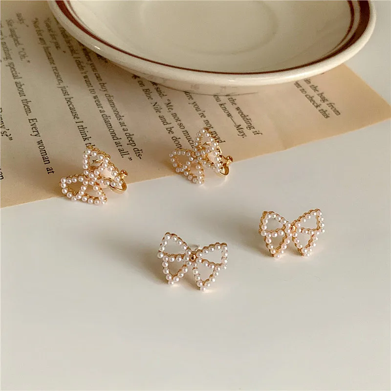 

Korean Fashion Hollow Bowknot Stud Earrings for Women Simulated Pearls Bow Tie Clip On Earrings Without Pierced Jewelry Gifts