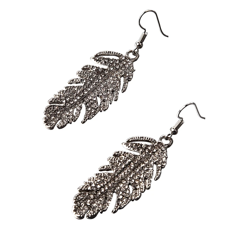 

Женские серьги с кристаллами и перьями