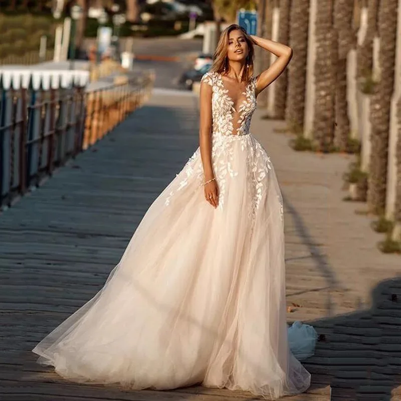 

Charming A-Line Tulle Wedding Dresses 2021 Sheer O-Neck Appliques Cap Sleeve Sweep Train Beach Bridal Gown With Button Back