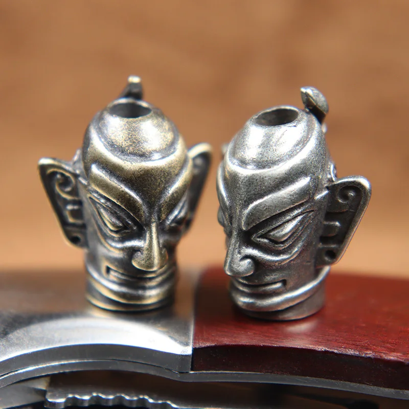 

Ancient Chinese Big Eyes Ears Mask Knife Beads Metal Brass Woven Paracord Lanyard Pendants EDC Outdoor Tool Charms DIY Accessory