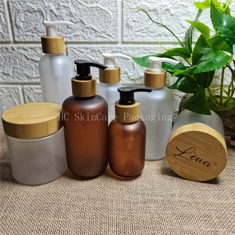 

Cosmetic Bottle Cream Jar With Bamboo Wood Lid Frosted Clear Plastic Container Skin Care Packaging Bottle Custom Logo Bottles