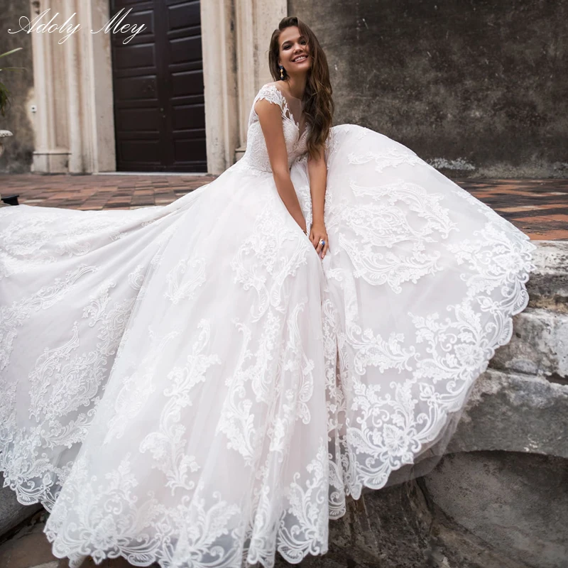 Свадебные платья-трапеции Adoly Mey со шлейфом и гламурной аппликацией элегантное