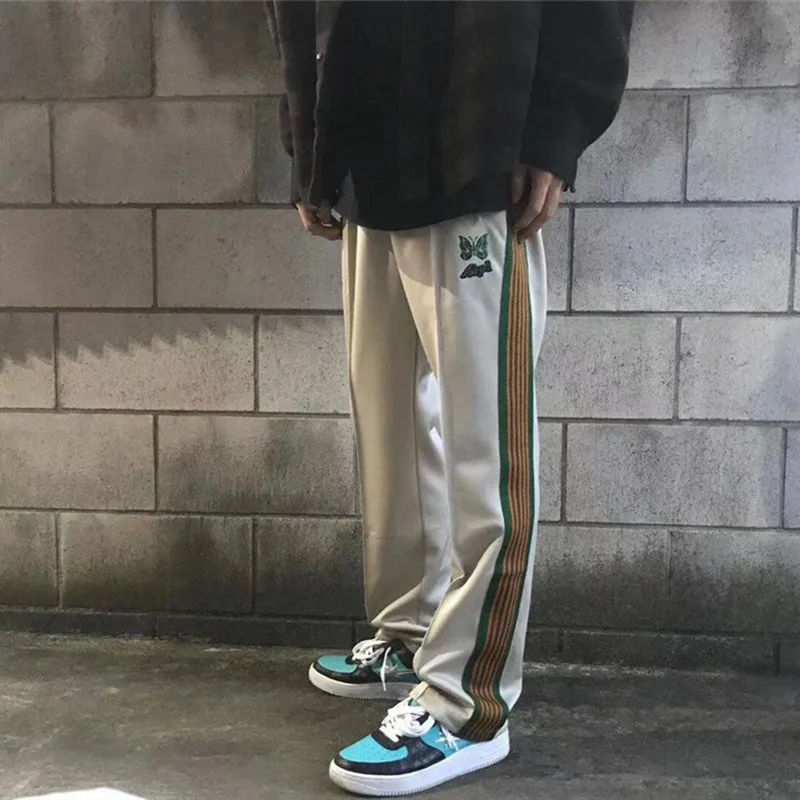 

Beige Needles Pants Men Women Butterfly embroidery Logo Needles Sweatpants Streetwear AWGW Pants Side stripe Patchwork