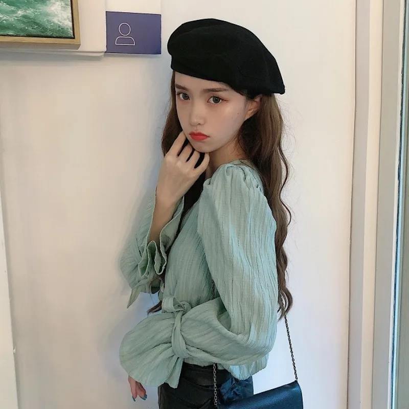 

Spring 2021 new retro V-neck pearl buckle wild trumpet sleeve tie shirt female design sense niche top