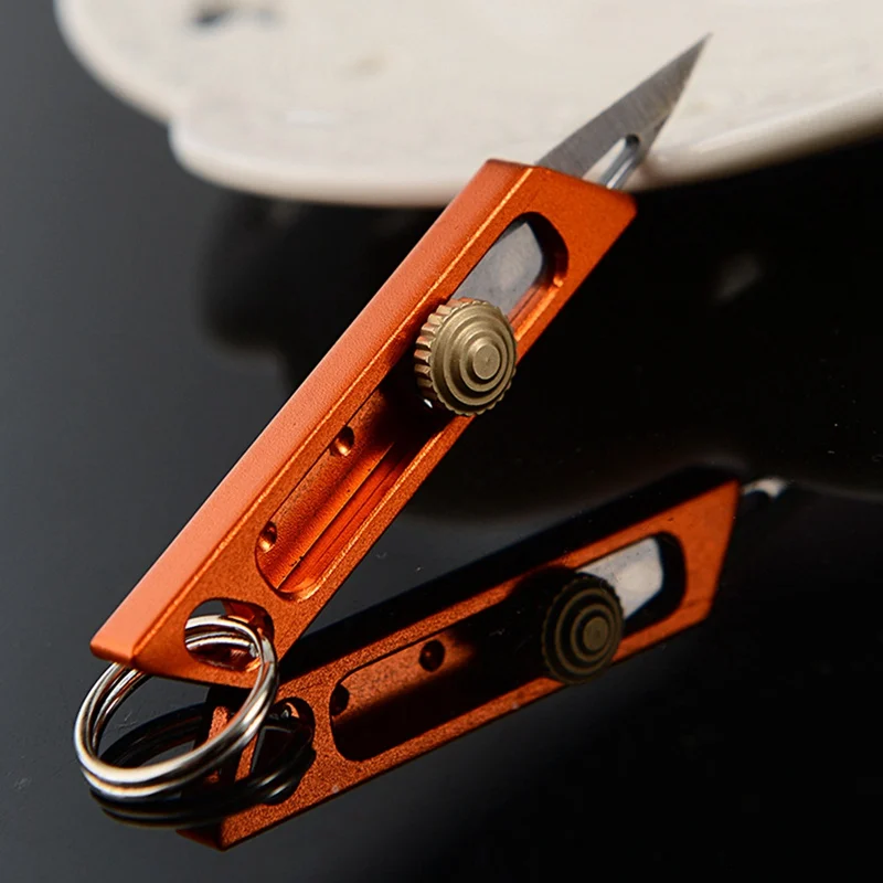 

1Pcs Outdoor Small Retractable Cutter Tools Mini Knife Paper Cutter High Hardness Carbon Steel Key Chain Cutting Multi Tools