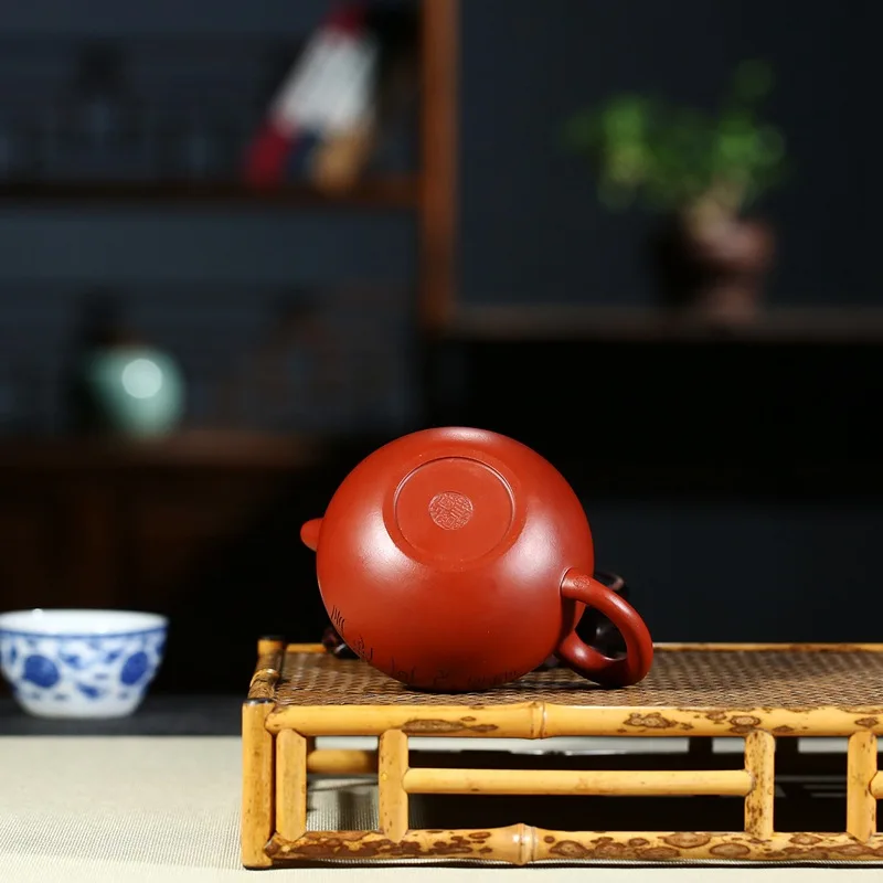 

Yixing hand-made purple clay teapot with landscape and ball carving