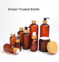 bamboo cosmetic packaging cbd 60ml 120ml 250ml 500ml amber frosted plastic pet pump lotion oil bottle with bamboo wooden lid 8oz
