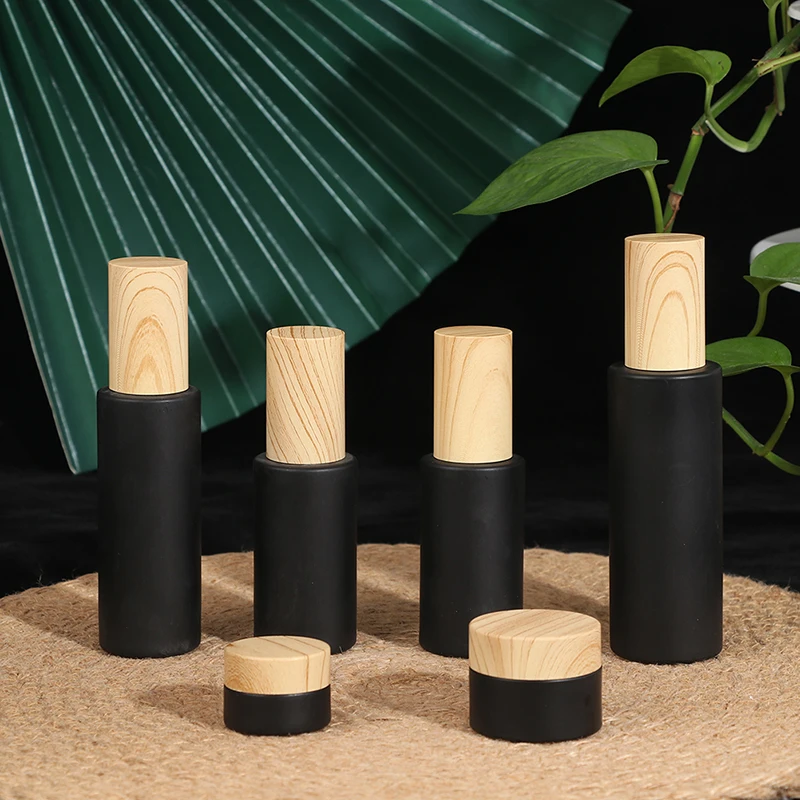 

Frosted Matt Black Glass Eye Cream Cosmetic Container Spray Lotion Bottle Jars Refillable Bottle With Wood Grain Cover
