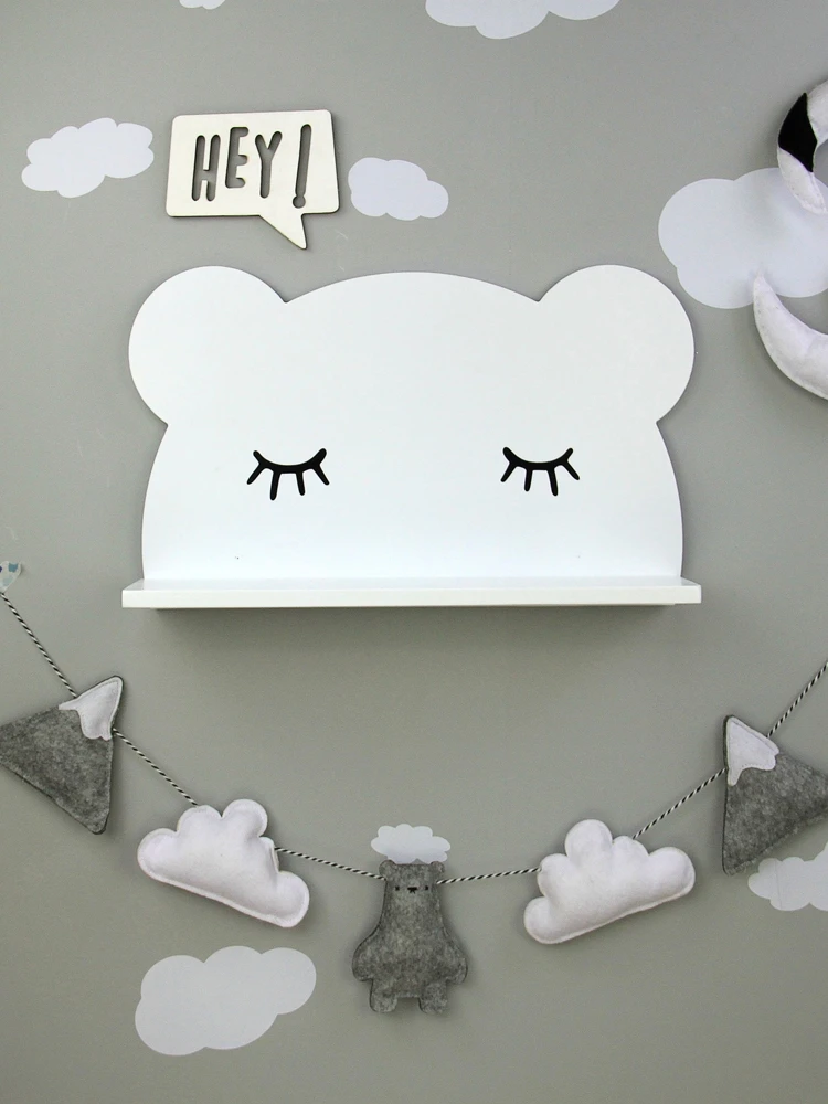 

The wall of the children's room is decorated with a non perforated shelf