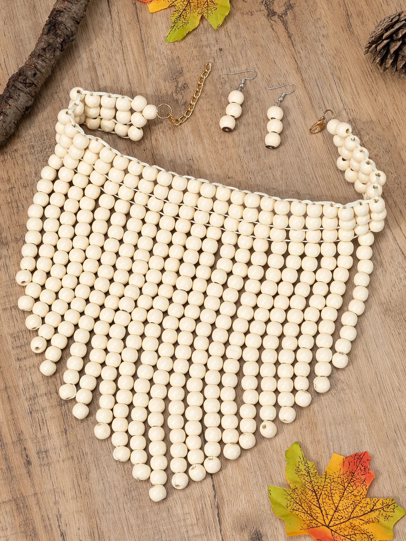 

Women's necklaces and earrings in a stylish set of white wooden jewelry are included in the package