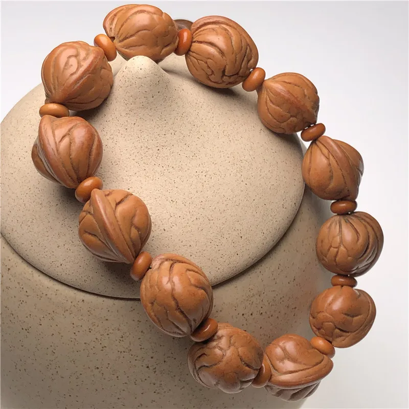 Браслет рыбий глаз из ореха и золота 18 мм слева