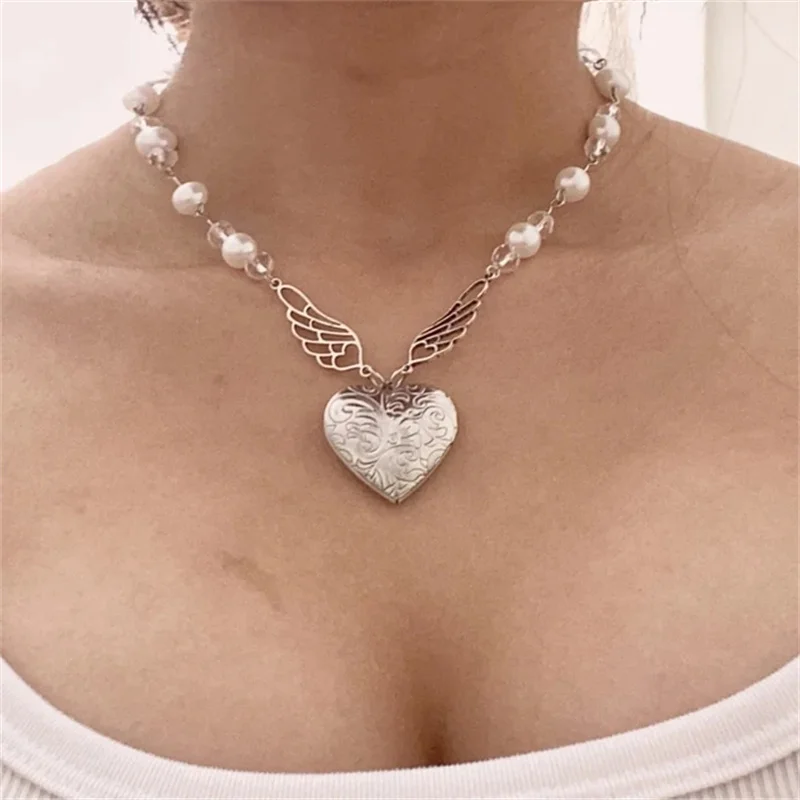 

Clear & White Beaded Necklace With Angel Wings | Faux Pearls | Heart Locket