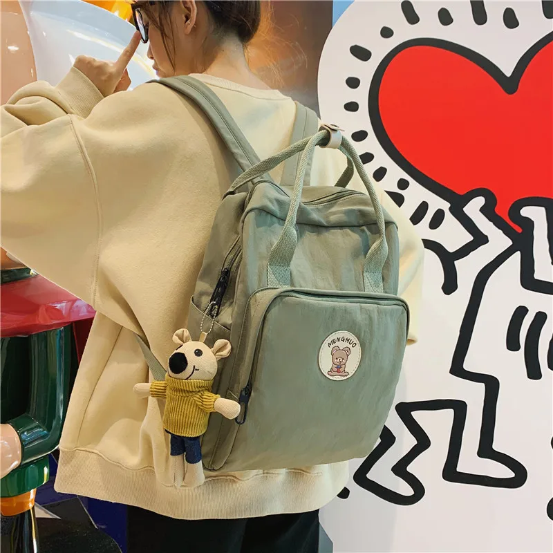 

2022 winter new product Korean version of the style port backpack simple solid color bear label student school bag