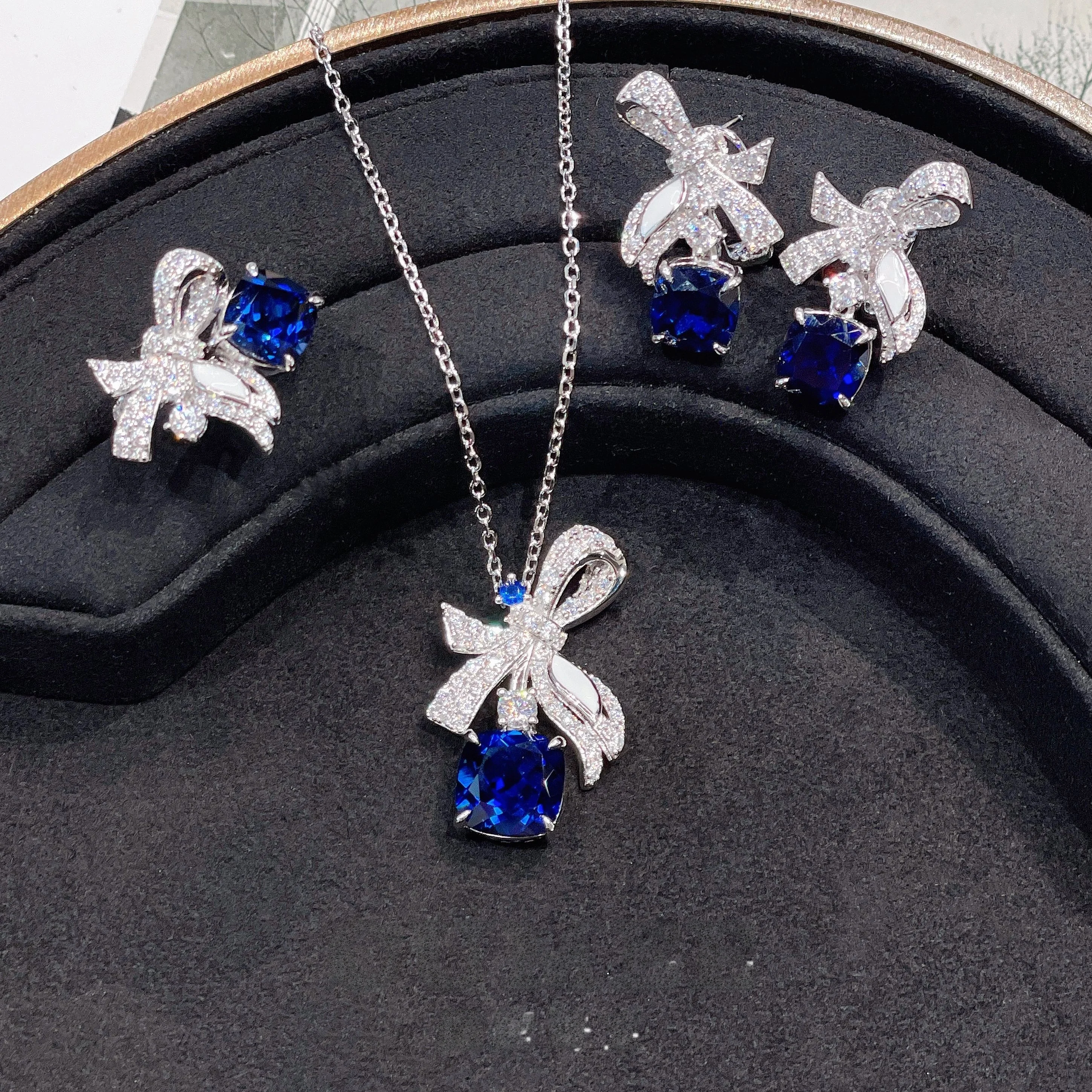 Новый универсальный комплект с синтетическим сапфиром и бантом. Посеребренный