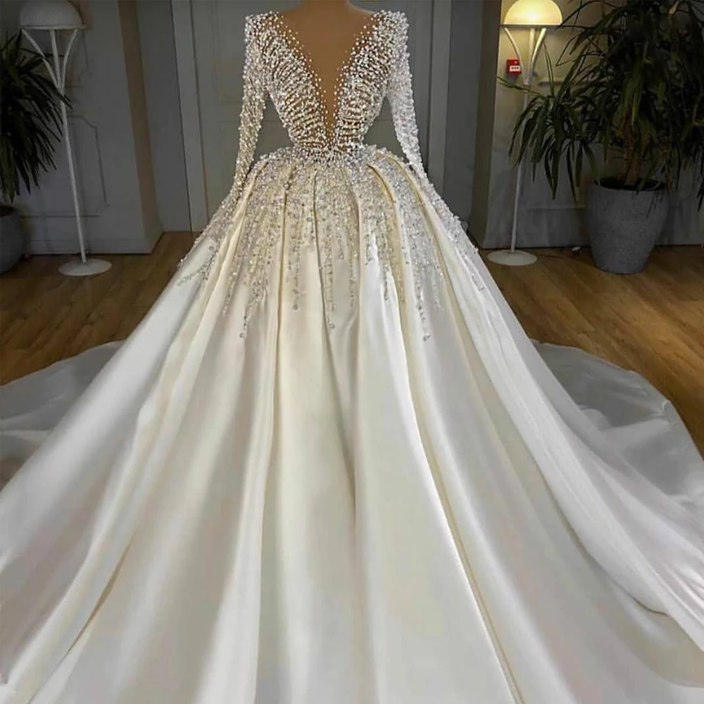 

Deep V-neck Long Sleeve Princess Ball Gown Wedding Dress Pearls Beaded Dubai Satin Custom Made Bridal Gown 2023