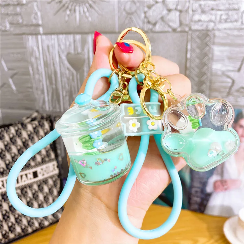 

Creative Entering the Oil Fairy Palm Floating Bottle Keychain Liquid Flow Sand Bottle Pendant Doll Gift Bag Jewelry Wholesale