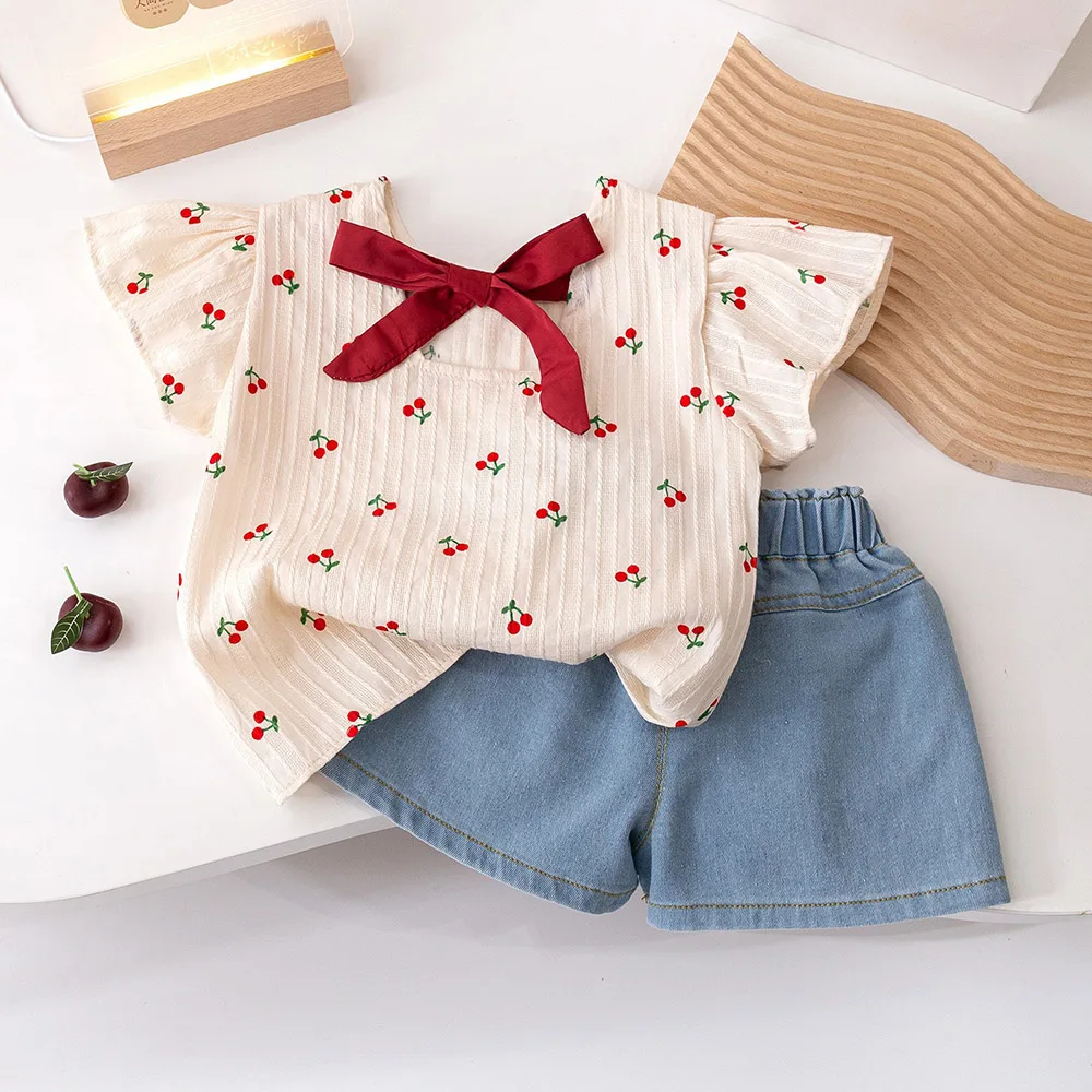 

Baby Girls Fly Sleeve T-Shirts Suit Summer Cartoon Cherry Print Bow T-shirt Kids Tops+Denim Shorts 2Pcs Children Clothes Set