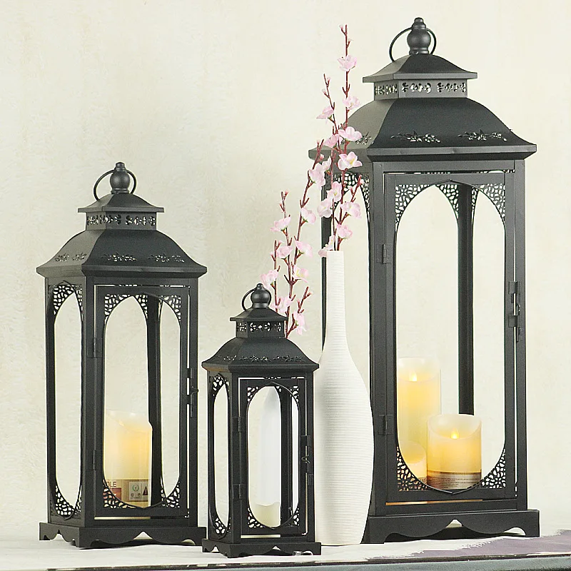 

Nordic Morocco Style Hollow-out Wrought Iron White / Black Painted Lantern Portable Lights Table Lamp for Wedding Decoration