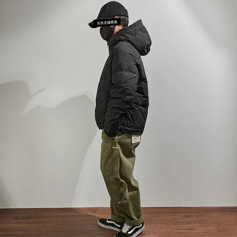 Hooded down jacket men's fake two pieces of loose shoulder sleeves in winter, the new warm outer wear black stitching jacket.