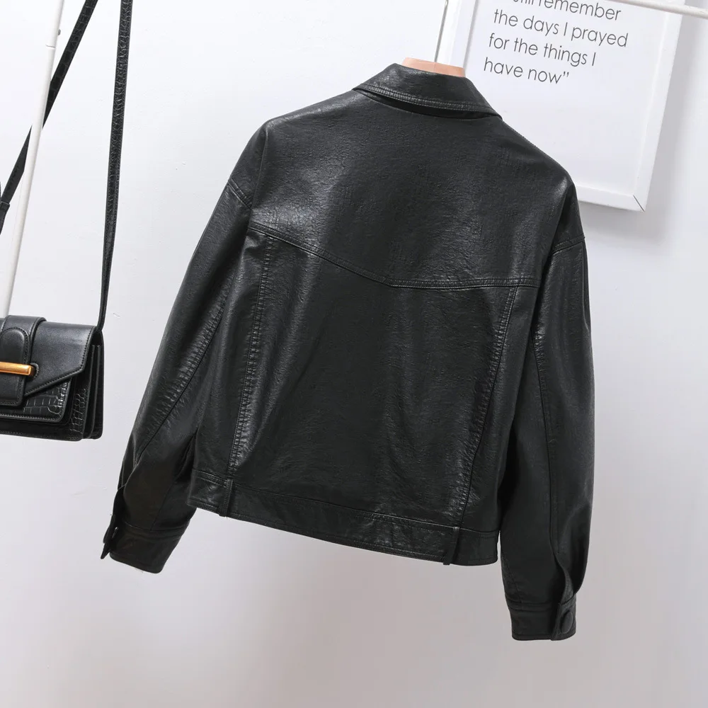 Single breasted loose version of women's short black lapel leather coat