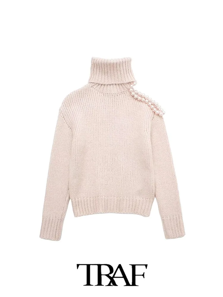 

Женский свитер с высоким воротом и искусственным жемчугом на плечах