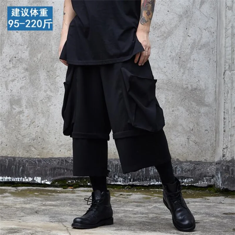 

Мужские брюки с большими карманами, поддельные брюки из двух частей с широкими штанинами, оригинальный дизайн, Парикмахерская одежда, повседневная черная полая одежда, パンштаны, мужиской