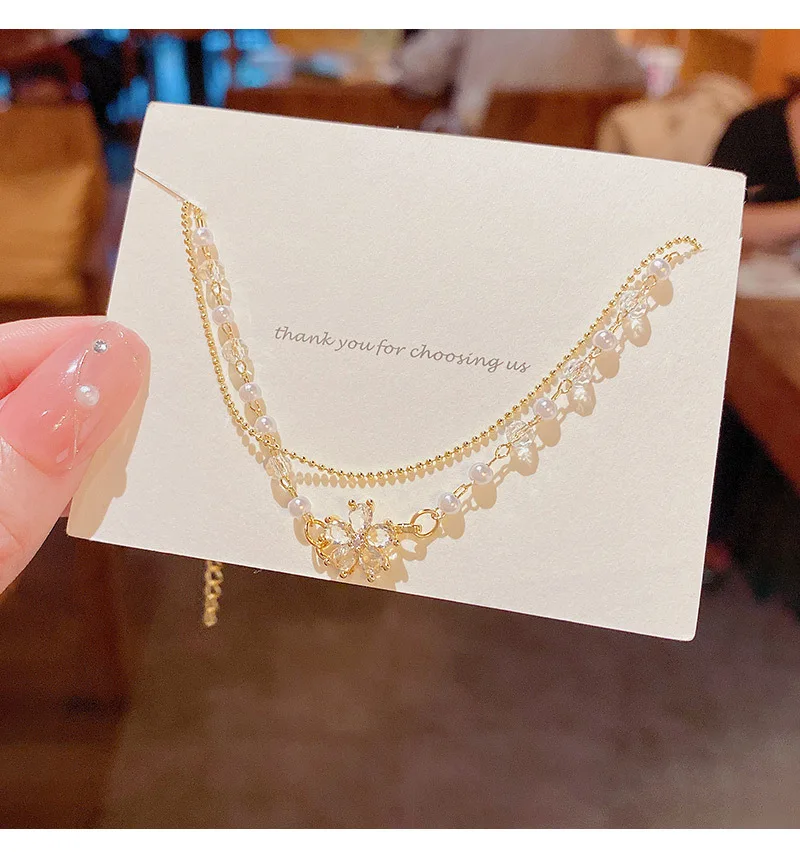 

ins tide titanium steel double-layer pearl bracelet female super flash exquisite zircon flower pendant hand string new Korean ha