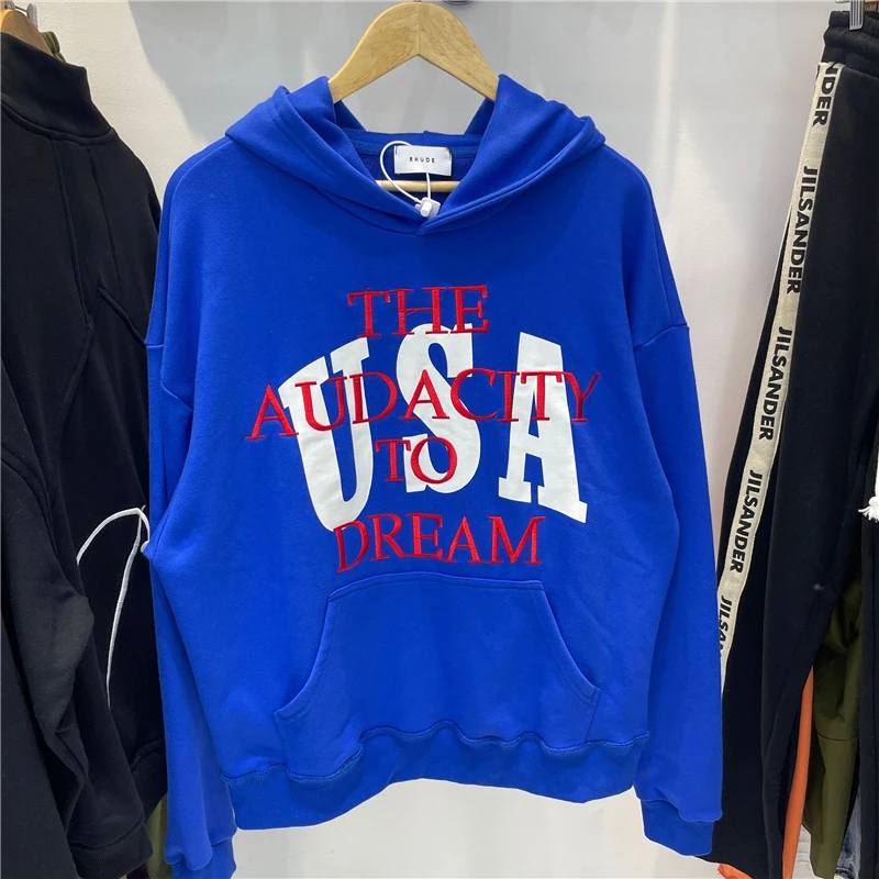 

Blue RHUDE Hoodie Men Women 1:1 High Quality Embroidery THE AUDACITY DREAM USA Overlapping Text RHUDE Hooded Loose Pullover