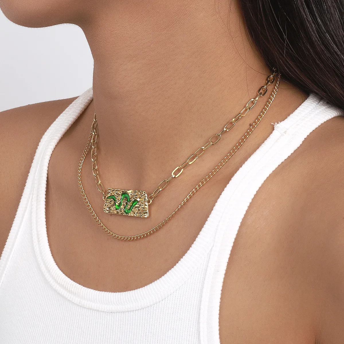 Accessories: Layered with a statement snake element necklace, exaggerated hip-hop punk style necklace