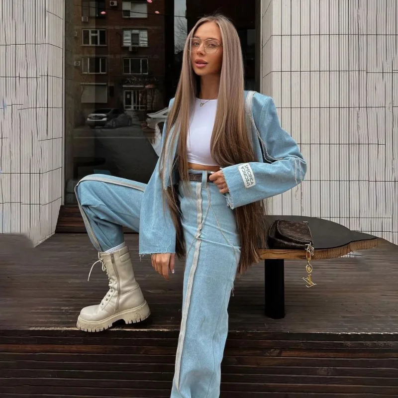 Индивидуальные женщины с короткой курткой отделкой по краям и прямыми джинсами в