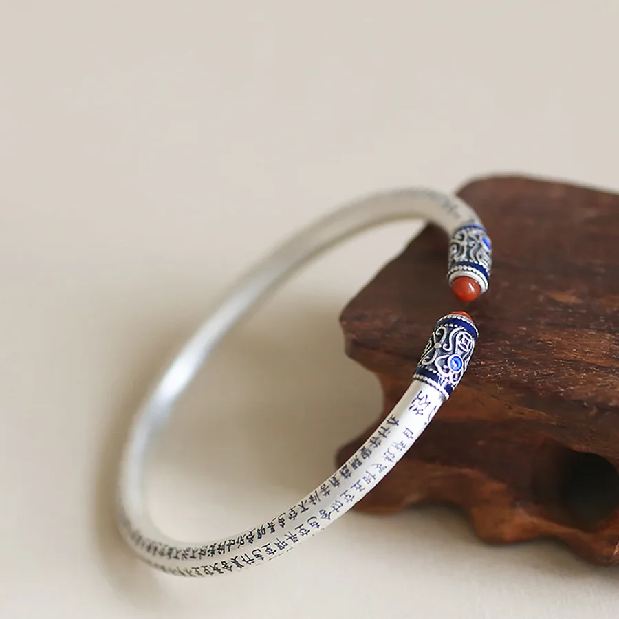 

Female matte hollow opening antique style bracelet with engraved characters on the inner side